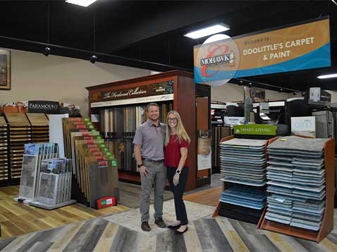 Business owners posing for a photo in the showroom