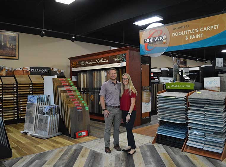 Business owners posing for a photo in the showroom