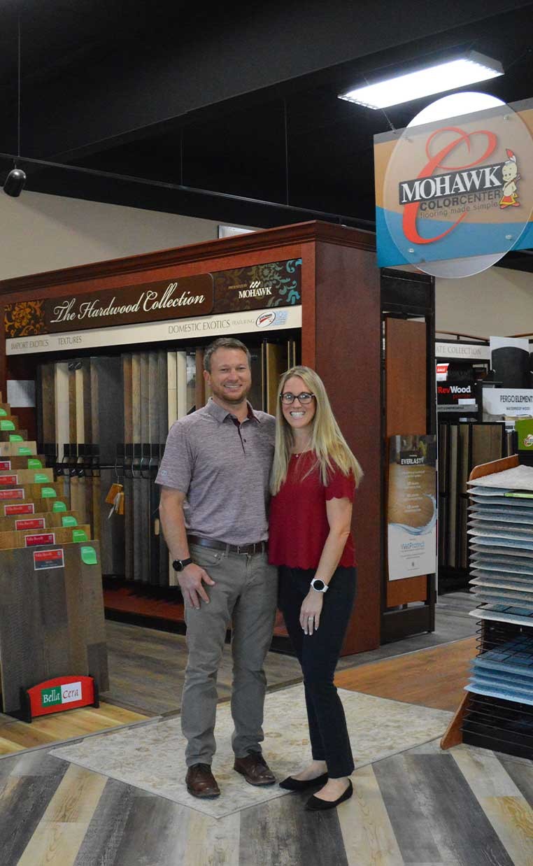 Business owners posing for a photo in the showroom
